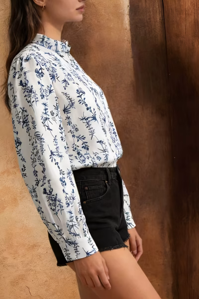 Model in Porcelain Floral Chinese Style Long-Sleeve Puff Sleeve vintage niche blouse side profile with black denim shorts